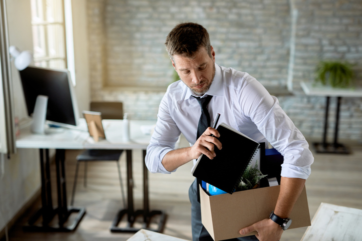 Male entrepreneur packing his belongings after being fired at work. Canadian Natural Resources