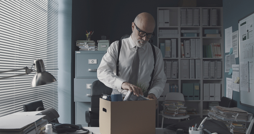 Businessman packing and leaving the office Canadian Natural Resources