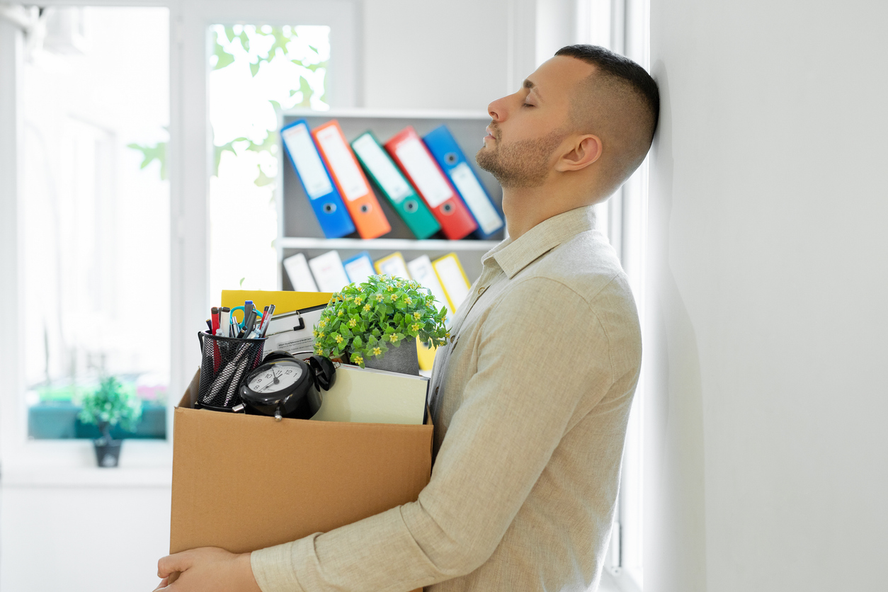 Man feeling depressed after losing his job Almaden-Minerals-layoffs-know-your-rights