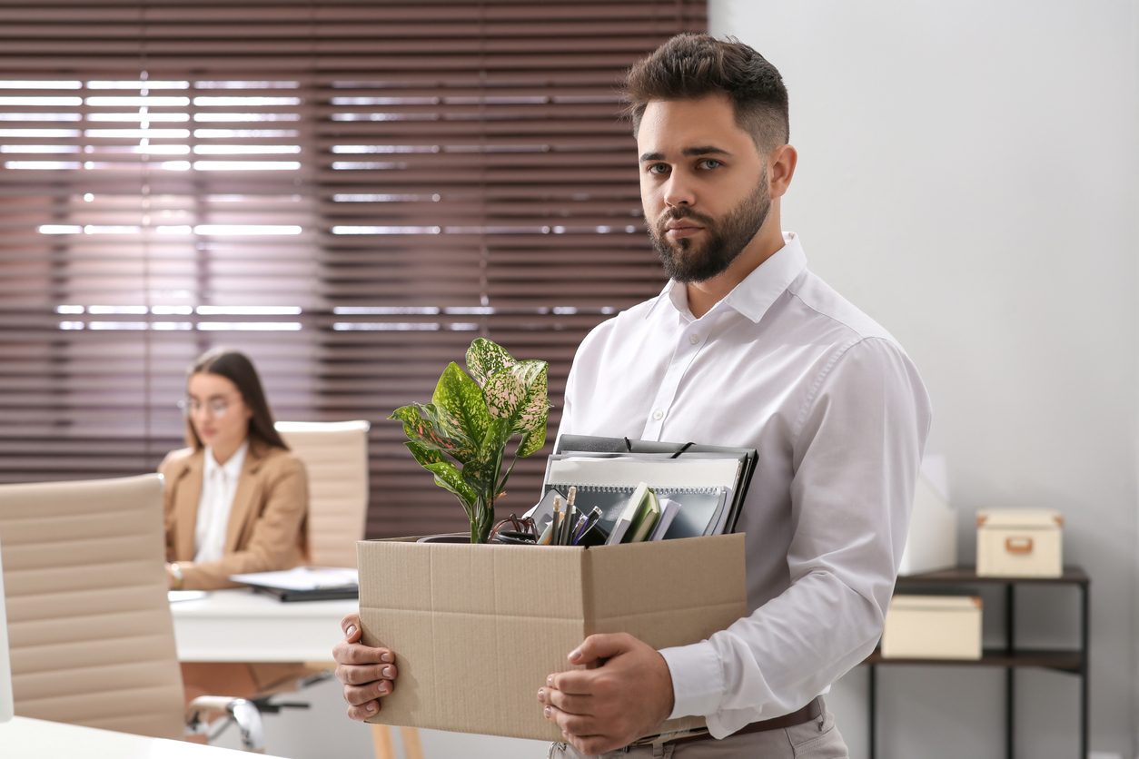 Upset dismissed man carrying box with personal stuff in office Orosur-Mining-know-your-rights