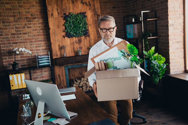 Photo of handsome mature mister leave workspace carry box dressed white shirt formalwear comfortable startup office loft room interior trillium-gold-mines-layoffs-know-your-rights