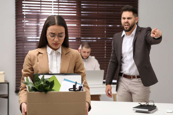 Boss dismissing young woman from work in office gran-tierra-energy-layoffs-know-your-rights